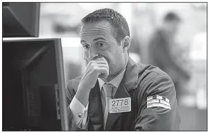  ?? AP/RICHARD DREW ?? Specialist Michael Gagliano works Wednesday on the floor of the New York Stock Exchange. About seven stocks fell for every two that rose on the exchange.