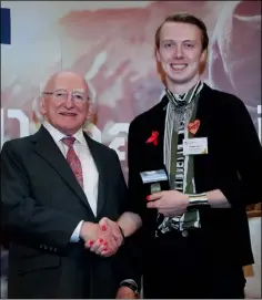  ??  ?? Former St Peter’s College student Gareth Jones receives his Gaisce Gold Award from President Michael D. Higgins.