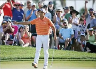  ?? WILFREDO LEE — THE ASSOCIATED PRESS ?? Fans cheer for Rickie Fowler after his putt on the 12th Classic, Sunday in Palm Beach Gardens, Fla. hole during the final round of the Honda