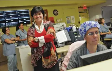  ?? TARA WALTON/TORONTO STAR ?? Credit Valley Hospital president Michelle Diemanuele, centre, says her facility worked hard to improve patient care.