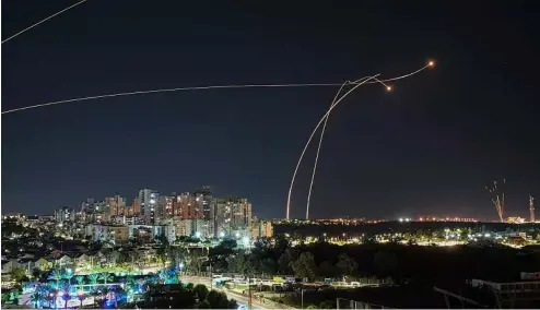  ?? ?? Israel's Iron Dome air defence system fires to intercept a rocket fired from the Gaza Strip, in Ashkelon, Israel, Tuesday, Oct. 17, 2023.