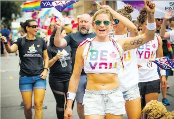  ?? ASHLEY FRASER ?? More than 130 groups — from community organizati­ons and sports teams, to embassies and local businesses — along with thousands of spectators fill the streets for the Capital Pride Parade on Sunday.