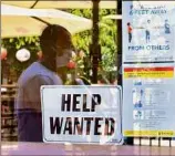  ?? Frederic J. Brown / Getty Images ?? A “Help Wanted” sign is posted beside coronaviru­s safety guidelines in front of a restaurant in Los Angeles on May 28. Employers are growing increasing­ly desperate to hire new workers.