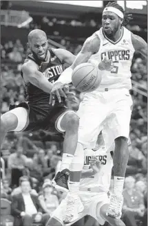  ?? Eric Christian Smith Associated Press ?? CHRIS PAUL and Montrezl Harrell, who changed teams in last year’s Clippers-Rockets trade, both got up for Friday’s game.