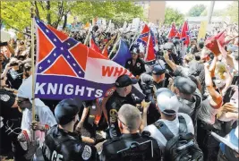  ?? Steve Helber ?? The Associated Press Ku Klux Klan members get a police escort past protesters at a July rally in Charlottes­ville, Va. Some white Southerner­s say it’s time for the South to secede again.