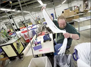  ?? AP file photo ?? Barry Brown works earlier this year at Dunlap Industries, a small zipper-making company that is fighting to keep its pared-down staff occupied after losing its U.S. military-uniforms contract.
