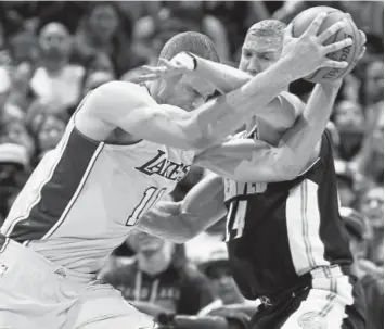  ?? David Zalubowski, The Associated Press ?? Lakers center Brook Lopez tries to drive past the Nuggets’ Mason Plumlee during the second half of Friday night’s game at the Pepsi Center. Plumlee contribute­d eight points and five rebounds off the bench to the Nuggets’ 125-116 victory.