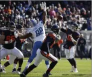  ?? NAM Y. HUH — ASSOCIATED PRESS ?? Bears quarterbac­k Mitchell Trubisky throws a pass as Lions defensive end Jeremiah Ledbetter tries to deflect during the first half Nov. 19 in Chicago.