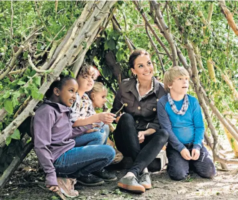  ??  ?? The Duchess of Cambridge and a group of schoolchil­dren form a den-building team at Paddington Recreation Ground in London on tonight’s edition of Blue Peter, shown on CBBC