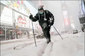  ?? JOHN MINCHILLO — THE ASSOCIATED PRESS ?? Steve Kent skis through Times Square during a snowstorm Feb. 1in the Manhattan borough of New York.