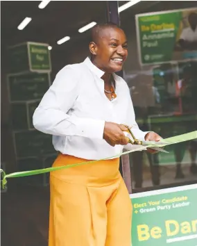  ?? COLE BURSTON / THE CANADIAN PRESS ?? Federal Green Party Leader Annamie Paul cuts the ribbon at the opening
of her campaign office in Toronto Centre on Thursday.