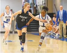  ?? STAFF PHOTO BY ROBIN RUDD ?? Host Trion’s I’Ziah McCutchins, right, dribbles upcourt with a Paideia turnover during Wednesday night’s game in the first round of the GHSA Class A Division I state tournament.