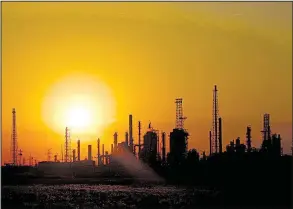  ?? Bloomberg News/LUKE SHARRETT ?? The sun sets behind the BP-Husky Toledo Refinery in Oregon, Ohio, on June 13. Mexico relies on U.S. natural gas to fuel more than a quarter of its electricit­y production, but the market faces disruption if there is a renegotiat­ion of the North American...