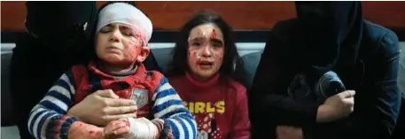  ??  ?? Wounded Syrians await treatment at a clinic in Hamouria, in Eastern Ghouta. Photo: Abdullah Hammam/AFP/Getty Images