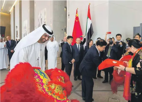  ?? Adnoc ?? Dr Sultan Al Jaber, the chief executive of Adnoc, and CNPC chairman Wang Yilin watch preparatio­ns for a Chinese ‘lion dance’