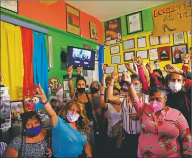  ??  ?? Sex workers raise their fists in solidarity after telling stories about their experience­s during a nationwide online event to advocate against human traffickin­g and in favor of rights and recognitio­n for sex workers.