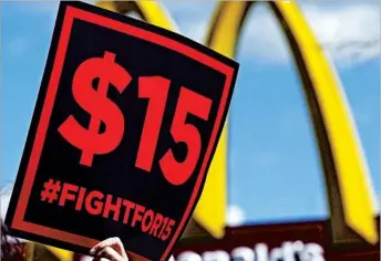  ?? AP/FILE ?? Several workers fought for minimum wage raises across the country, with the highest new wage at $11.