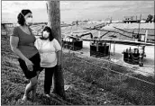  ?? LINDA DAVIDSON/WASHINGTON POST ?? Dawn Chapman, left, and Karen Nickel wear protective masks at the West Lake Landfill in Bridgeton, Mo.