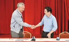  ?? — reuters ?? Passing the baton: Hsien loong shaking hands with Wong during a news conference at the istana in Singapore.