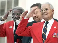  ?? Associated Press ?? ■ Tuskegee Airmen, Cicero Satterfiel­d, left, Lucius Theus, center, and Charles McGee, right, salute while posing for a group photo on the steps of the Capitol during a ceremony kicking off a nationwide fundraisin­g drive for a memorial to the Tuskegee Airmen, Monday Dec. 18, 2006, in Montgomery, Ala. McGee, one of the last surviving Tuskegee Airmen who flew 409 fighter combat missions over three wars, died Sunday. He was 102.