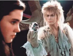  ?? COLUMBIA/TRISTAR ?? Goblin king David Bowie, right, tempts Jennifer Connelly in the 1986 fantasy “Labyrinth.”