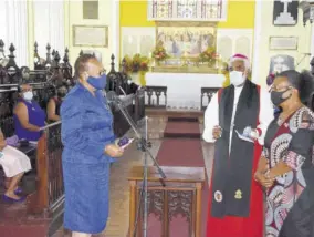  ??  ?? Director of Anglican Schools Ena Barclay ( left) presents a gift to Charmaine Thompson, wife of Bishop Robert Thompson, in recognitio­n of the years of support to the work of the diocese and her husband’s bishopric.