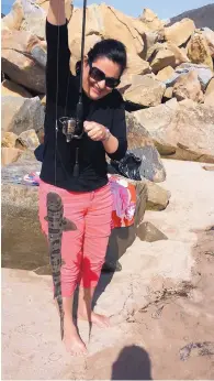  ??  ?? Laura Gómez shows off the leopard shark she caught surf fishing on a beach in California. She took up the sport a couple of years ago and finds it a relaxing diversion from her academic career.