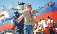  ?? COSTAS METAXAKIS / AGENCE FRANCE-PRESSE ?? A coast guard carries a refuge child after disembarki­ng from a vessel on the island of Crete, Greece, on Tuesday.