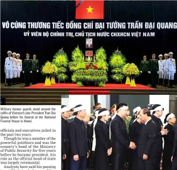  ??  ?? Military honour guards stand around the coffin of Vietnam’s late President Tran Dai Quang before his funeral at the National Funeral House in Hanoi. Vietnam’s Prime Minister Nguyen Xuan Phuc shares a moment with family members after he paid respects to Vietnam’s late President. — Reuters photos