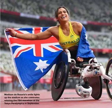  ?? ?? Madison de Rozario’s smile lights up the stadium as she celebrates winning the T54 marathon at the Tokyo Paralympic­s in September.