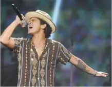  ?? Al Powers/Invision/The Associated Press ?? Bruno Mars may choose a slightly different ensemble when he plays the halftime show at the Super Bowl in chilly New Jersey.