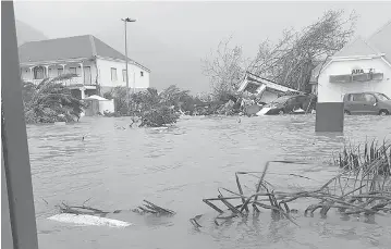  ?? RINSY XIENG/AFP/GETTY IMAGES ?? A handout picture on the Twitter account of RCI Guadeloupe shows a flooded street on the French island of Saint Martin, after it was hit with high winds from Hurricane Irma.