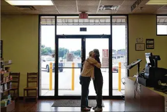  ?? LYNDA M. GONZALEZ / AMERICAN-STATESMAN ?? Lock Drug pharmacy employee Earlene Simons hugs a customer goodbye as the Bastrop drugstore, after 49 years in business, announced it was closing its doors. Many local residents say it’s “an end of an era.”