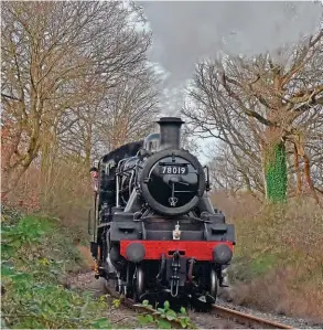  ?? OWEN HAYWARD ?? Standard bearer: Visiting from the Great Central Railway, BR Standard 2MT 2-6-0 No. 78019 approaches Tenterden Town on December 29. Trackside are trees that in summer are home to some of the diverse wildlife that is currently at the heart of a major sustainabi­lity study being conducted by the railway.