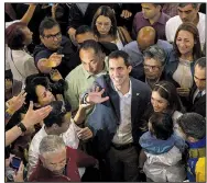  ?? AP/RODRIGO ABD ?? Venezuelan opposition leader Juan Guaido greets supporters Sunday after attending Mass in Caracas. Guaido, whom the U.S. recognizes as Venezuela’s rightful leader, urged his country’s military to use caution in a dispute with doctors over humanitari­an aid. President Nicolas Maduro has vowed not to let the supplies be accepted.