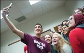  ?? BEA AHBECK/NEWS-SENTINEL FILE PHOTOGRAPH ?? Samuel Wright, who is signing with Harvard, takes a selfie with friends during a college signing ceremony at Lodi High on April 11. Wright is the Lodi High Class of 2019 valedictor­ian.