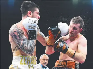  ?? Picture: GETTY IMAGES ?? CRUNCH: Michael Zerafa lands a heavy left on Jeff Horn on Saturday night.