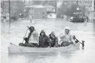  ?? CP ?? Left: Montreal Mayor Denis Coderre, centre, and Île Bizard Mayor Richard Bélanger, right, survey flooded streets on Montreal’s island suburb on Friday. Right: A canoe is used to cross Rue Saint-Louis in Gatineau, Que., on Friday.