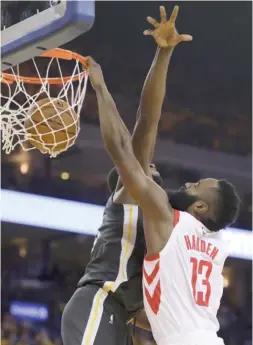 ??  ?? Rockets guard James Harden dunks againstWar­riors forward Draymond Green in the first half Tuesday. Harden finished with a game- high 30 points in the win.