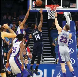  ?? (Reuters) ?? ORLANDO MAGIC guard D.J. Augustin (14) shoots over Detroit Pistons forward Blake Griffin (23) for two of his 20 points in the Magic’s 115-106 overtime home victory over the Pistons on Friday night.