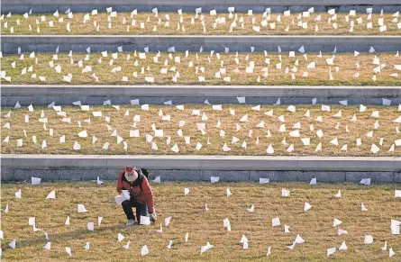  ?? CHARLIE RIEDEL/ AP ?? At the National World War I Museum and Memorial in Kansas City, Mo., flags honor victims of the pandemic.