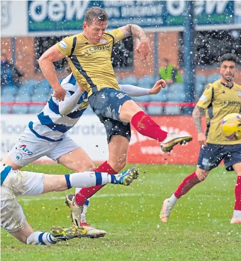  ??  ?? POINT MADE: Lee Ashcroft fires home the equaliser for Dundee in the clash with Morton at Dens. Below: Dundee’s Danny Mullen tussles for the ball with Stephen Mcginn of Morton.