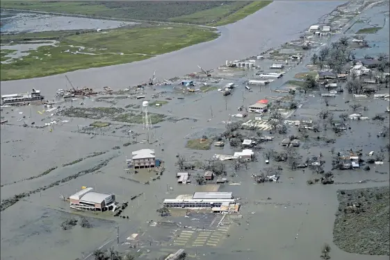  ?? DAVID J. PHILLIP / AP ?? Buildings and homes are flooded in the aftermath of Hurricane Laura Thursday in Cameron, La.