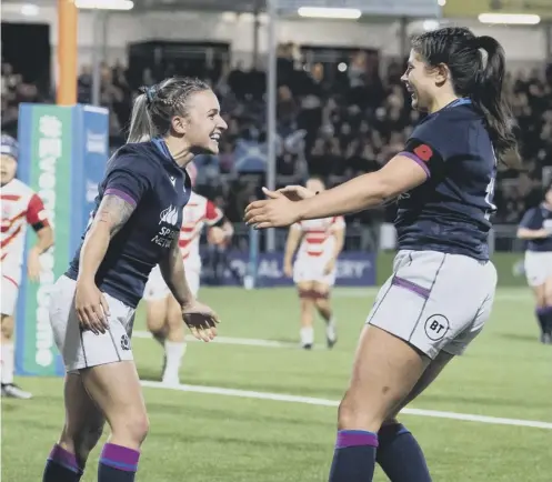  ?? ?? 0 Scotland’s Chloe Rollie, left, celebrates scoring a try during the win over Japan at the DAM Health Stadium