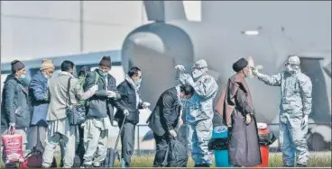  ?? PTI ?? ■
Indian nationals being screened at the airbase after they were evacuated from coronaviru­s-hit Iran at Hindon airport on Tuesday.