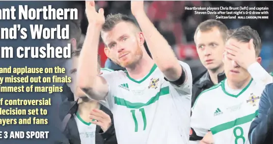  ?? NIALL CARSON/PA WIRE ?? Heartbroke­n players Chris Brunt (left) and captain Steven Davis after last night’s 0-0 draw with
Switzerlan­d