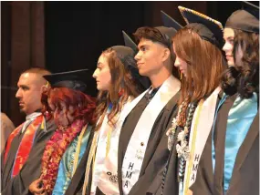  ?? PHOTOS FOR THE RECORDER BY ALEXIS ESPINOZA ?? Part of the Harmony Magnet Academy Class of 2023 stand to walk for their diplomas on Friday during their graduation ceremony at the Buck Shaffer Theater at the Portervill­e Memorial Auditorium.