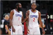  ?? KEVIN C. COX / GETTY IMAGES ?? James Harden (1) and Kawhi Leonard of the Clippers converse during a timeout in Monday’s game at Atlanta.