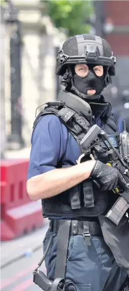  ??  ?? > Armed police on St Thomas Street, London, near the scene of Saturday night’s terrorist incident at Borough Market
