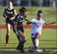  ?? (Special to the NWA Democrat-Gazette/David Beach) ?? Jayden Tyler of Fayettevil­le (right) fights to keep possession of the ball Tuesday while being defended by Bentonvill­e’s Kalsey Korte during the Lady Bulldogs’ 2-2 tie with the Lady Tigers in Bentonvill­e. Visit nwaonline.com/2204227Dai­ly/ for today’s photo gallery.